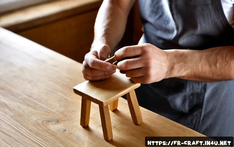 수공예 미니 공예 - Photorealistic close-up of a French artisan’s hands assembling a tiny handmade wooden miniature chai...